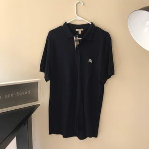 Man Burberry two button up shirt.